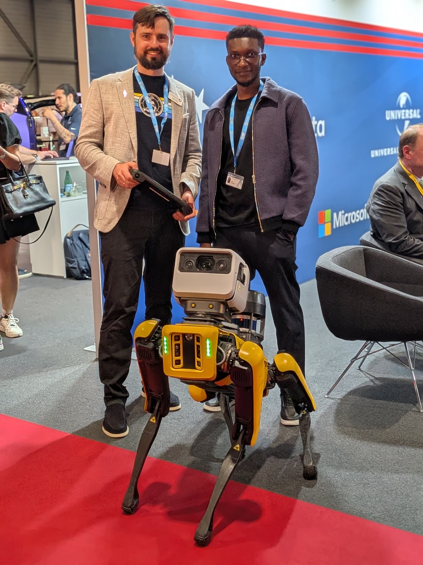 EO Robotics team members with a quadruped robot at an international tech summit